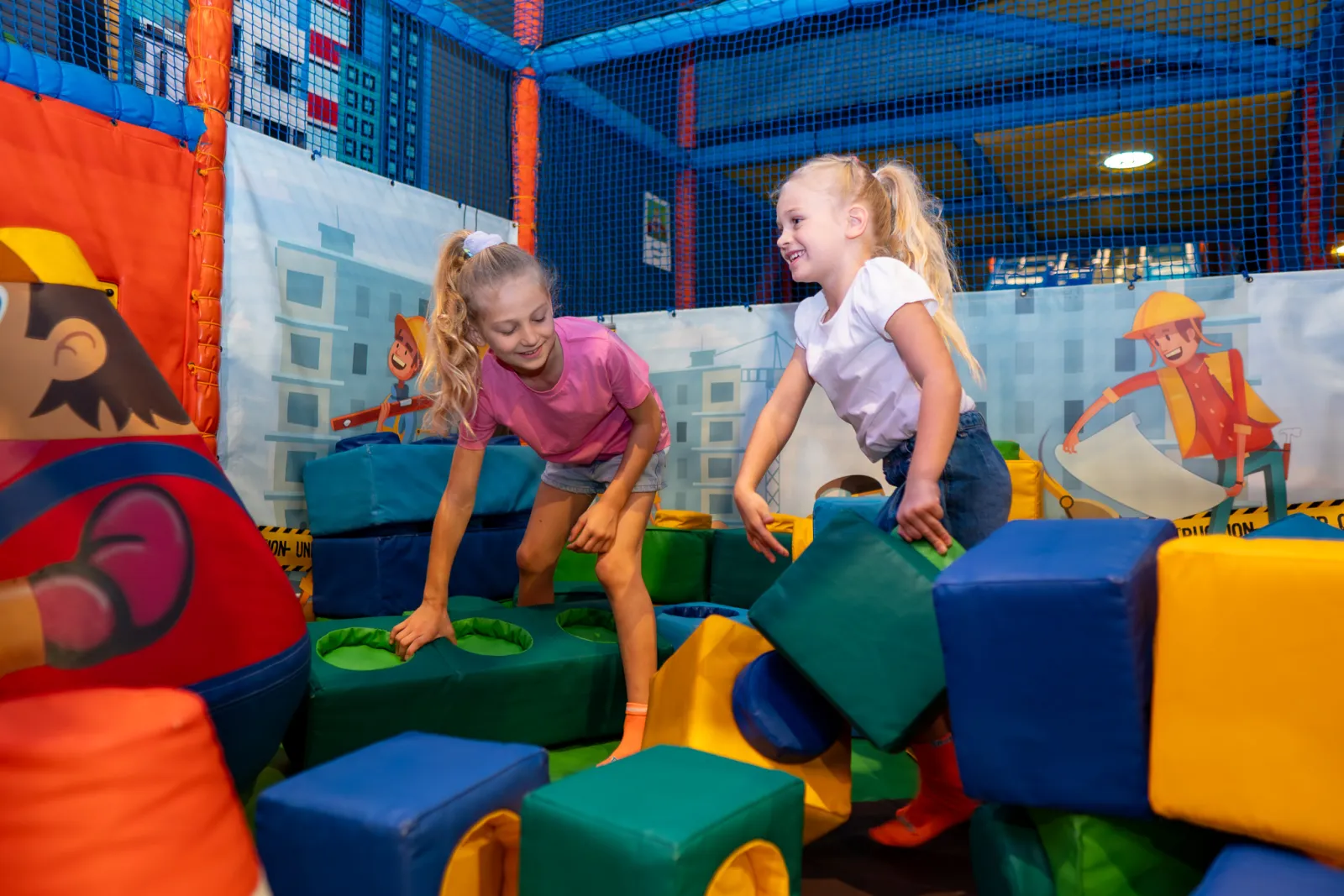 Girls playing with soft building blocks in the toddler area at Trampo